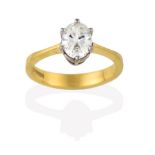 A Diamond Solitaire Ring, the oval cut diamond in a white claw setting, to a yellow tapered shoulder