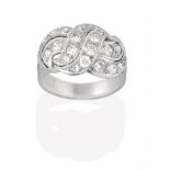 A Diamond Cluster Ring, of openwork scroll design, set throughout with round brilliant cut