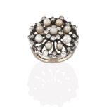 A Diamond and Seed Pearl Cluster Ring, the circular openwork plaque with a seed pearl centrally