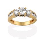 A Diamond Three Stone Ring, the graduated round brilliant cut diamonds in yellow claw settings, to a