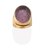 A 9 Carat Gold Glass Intaglio Ring, the purple glass carved to depict a gentleman in a yellow rubbed