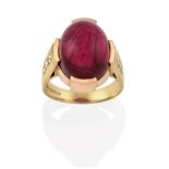 An 18 Carat Gold Pink Tourmaline Ring, the oval cabochon pink tourmaline in a yellow claw setting,