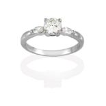 A Platinum Diamond Solitaire Ring, the round brilliant cut diamond in a claw setting, to marquise