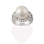 A Cultured Pearl and Diamond Ring, the cultured pearl within a round brilliant cut diamond border,