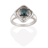 A Zircon and Diamond Cluster Ring, the blue-green zircon in a white claw setting, within a border of