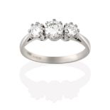 An 18 Carat White Gold Diamond Three Stone Ring, the graduated round brilliant cut diamonds, in claw