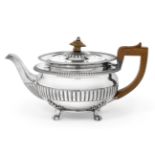 A George III Silver Teapot, by John Foskett and John Stewart, London, 1809, circular and on four paw