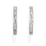 A Pair of Diamond Earrings, the white cuff form channel set with baguette cut diamonds, total