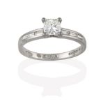 A Platinum Diamond Solitaire Ring, the princess cut diamond in a four claw setting, to baguette