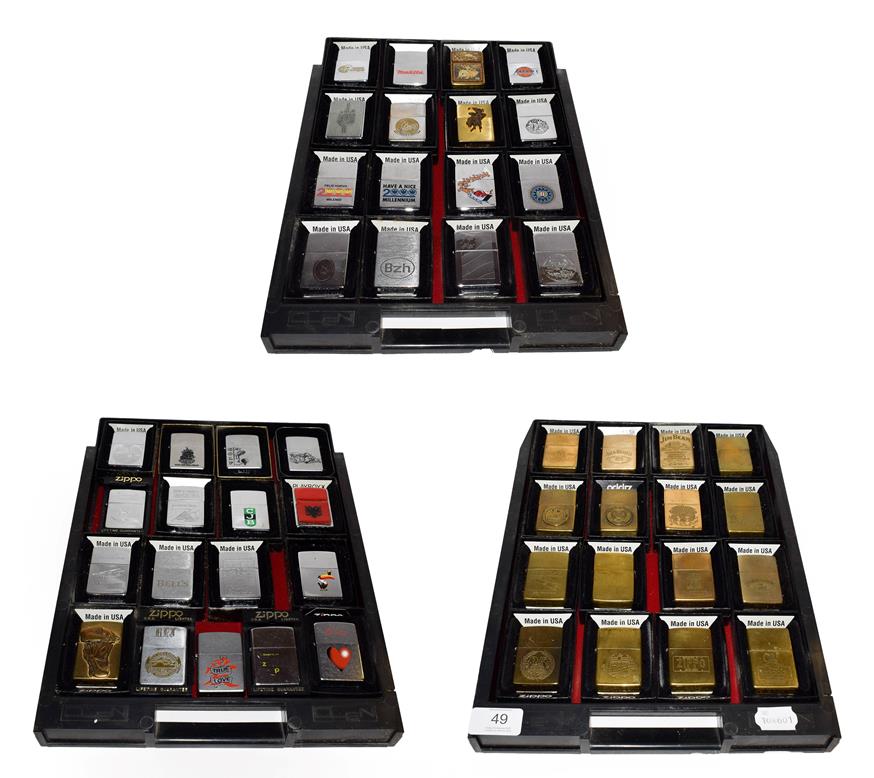 ~ A collection of Zippo lighters including advertising and brass examples (3 trays)