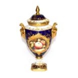 A Coalport twin handled urn and cover hand painted with apples and blackberries, signed M. Pinter,