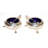 A pair of Victorian silver cauldron salt sellers with Bristol blue glass liners by Henry Holland.