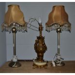A pair of modern silvered table lamps together with a gilt metal and onyx table lamp of urn form