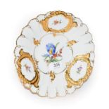 A 20th century Meissen gilt highlight plate decorated with floral sprays