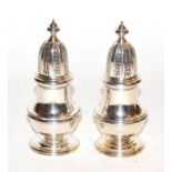 A pair of Elizabeth II silver baluster form pepper casters by William Comyns & Sons Ltd. Assayed