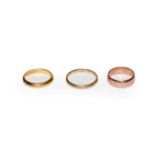 Three 9 carat gold band rings, finger sizes K, M and R. Gross weight 8.2 grams.