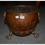 A 19th century copper log bucket, with ring and lion mask and paw feet