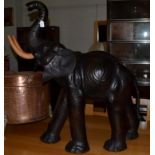 A leather covered model of a baby elephant, 20th/21st century, with composition tusks, 99cm high