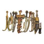 ~ A collection of mainly Indian kinjhals and daggers including some with metal mounted scabbards;