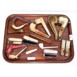 ~ A collection of cased meerschaum pipes, cheroot holders and a figural clay pipe (1 tray)