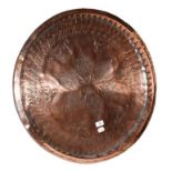 ~ A 19th century Continental copper serving tray with repoussé decoration, 85cm diamater