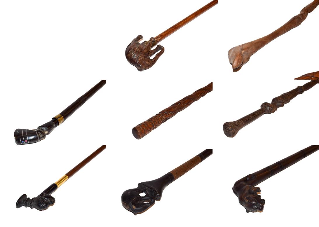 ~ A collection of carved walking sticks including African hardwood examples with figural and