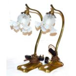 A pair of brass scoll formed table lamps with opaline glass shades