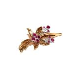 A 9 carat gold ruby brooch, realistically modelled as a floral spray, the yellow textured leaves