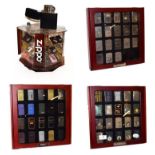 ~ Three collectors display cases containing a total of fifty-seven Zippo lighters, a rotating