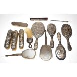 Assorted silver dressing table Items, including: various brushes and mirrors; a comb and a button