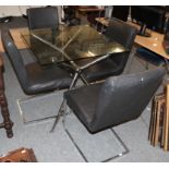 A glass top chromed metal table with four cantilever style chairs