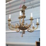 A gilt metal 8-light chandelier with reeded arms decorated with ribbon tied swags, drop