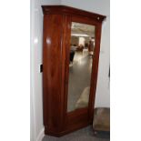 A large mirrored corner wardrobe, approximately 125cm by 80cm by 205cm high