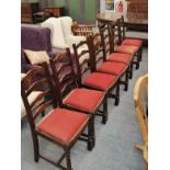 A set of seven reproduction ladder back dining chairs