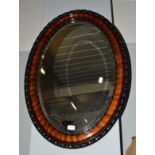 A mahogany oval mirror, 87cm by 62cm