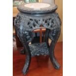 A Chinese pierced and carved hardwood marble top plant stand, 33cm diameter by 47cm