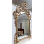 A carved and gilt composition Rococo style mirror decorated with scrolling acanthus leaves, 174cm by