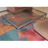 A wrought metal and glass coffee table, 150cm by 90cm