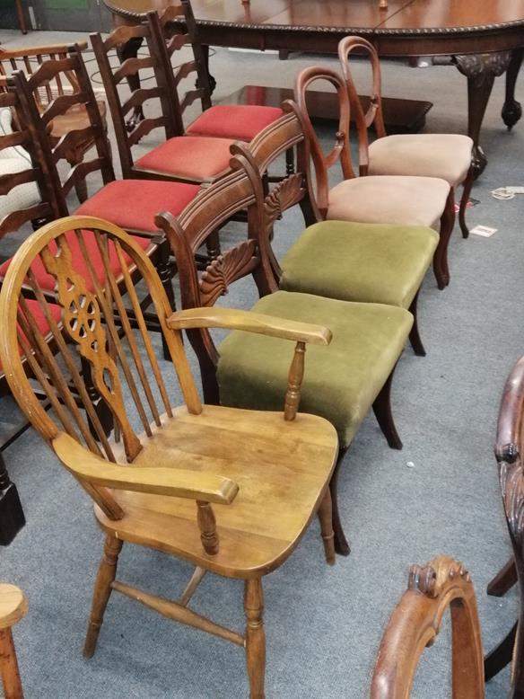 A pair of Regency carved mahogany dining chairs, a pair of Victorian balloon back chairs and a wheel