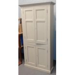 A 19th century painted pine farmhouse kitchen cabinet of slender form, with panelled doors, 105cm by