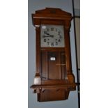 An Art Deco oak cased striking wall clock