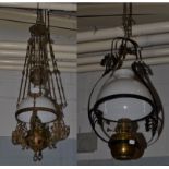 A 19th century brass and wrought iron hanging oil lamp, along with a similar rise and fall
