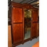 An Edwardian inlaid mahogany triple wardrobe, 187cm by 59cm by 223cm high