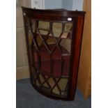 A George III mahogany bow-fronted handing corner cupboard, 67cm by 42cm by 104cm high