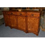 A reproduction inlaid burr walnut break front side board by Iain James, retailed by Elphicks, George