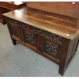 An 18th century carved oak three panel coffer, 130cm by 56cm by 73cm high