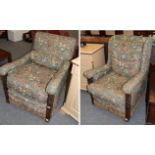 A pair of early 20th century carved oak armchairs, later recovered in floral fabric