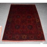 An Afghan Turkmen rug, the compartmentalised field enclosed by narrow borders, 195cm by 128cm