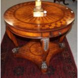 A reproduction bur walnut and mahogany veneered drum table, the circular top supported by four