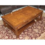 A reproduction burr walnut coffee table, with blind fretwork, and three drawers opposed by